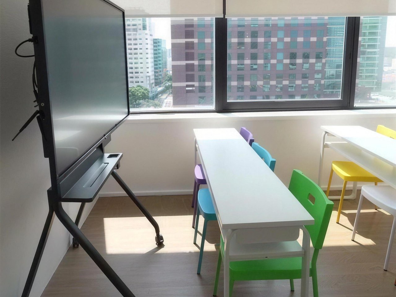Tian Yun classroom with a display board and natural light from city windows
